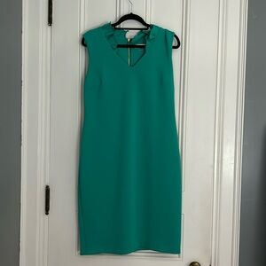 Sleeveless green Calvin Klein dress material is satin. Ruffle collar.
